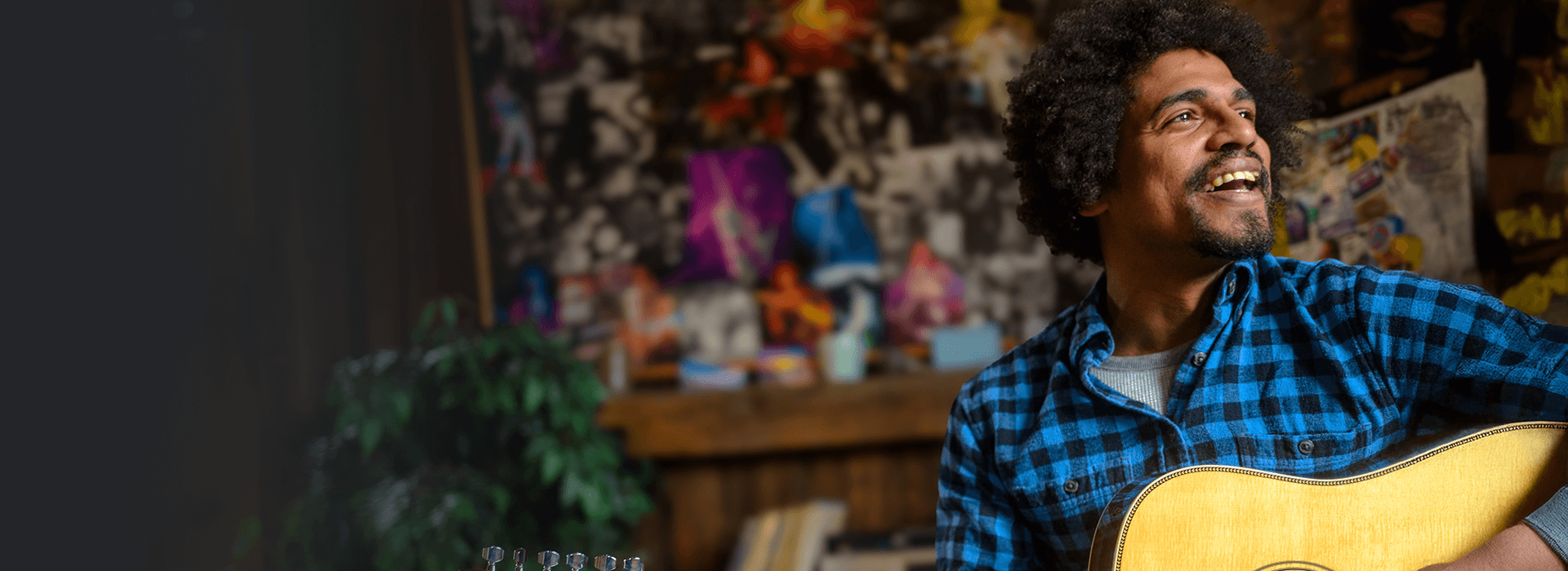 Guitar player enjoying a music session in a colorful indoor setting
