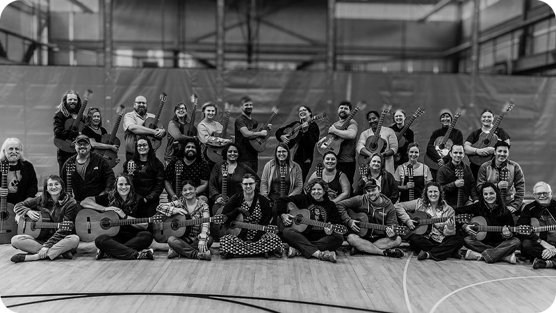 Workshop attendees gathered for a group picture with their guitars