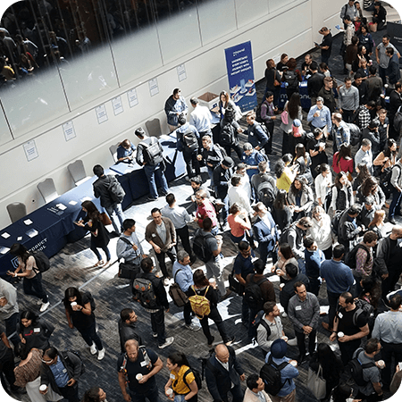 Attendees networking in a busy conference hall.